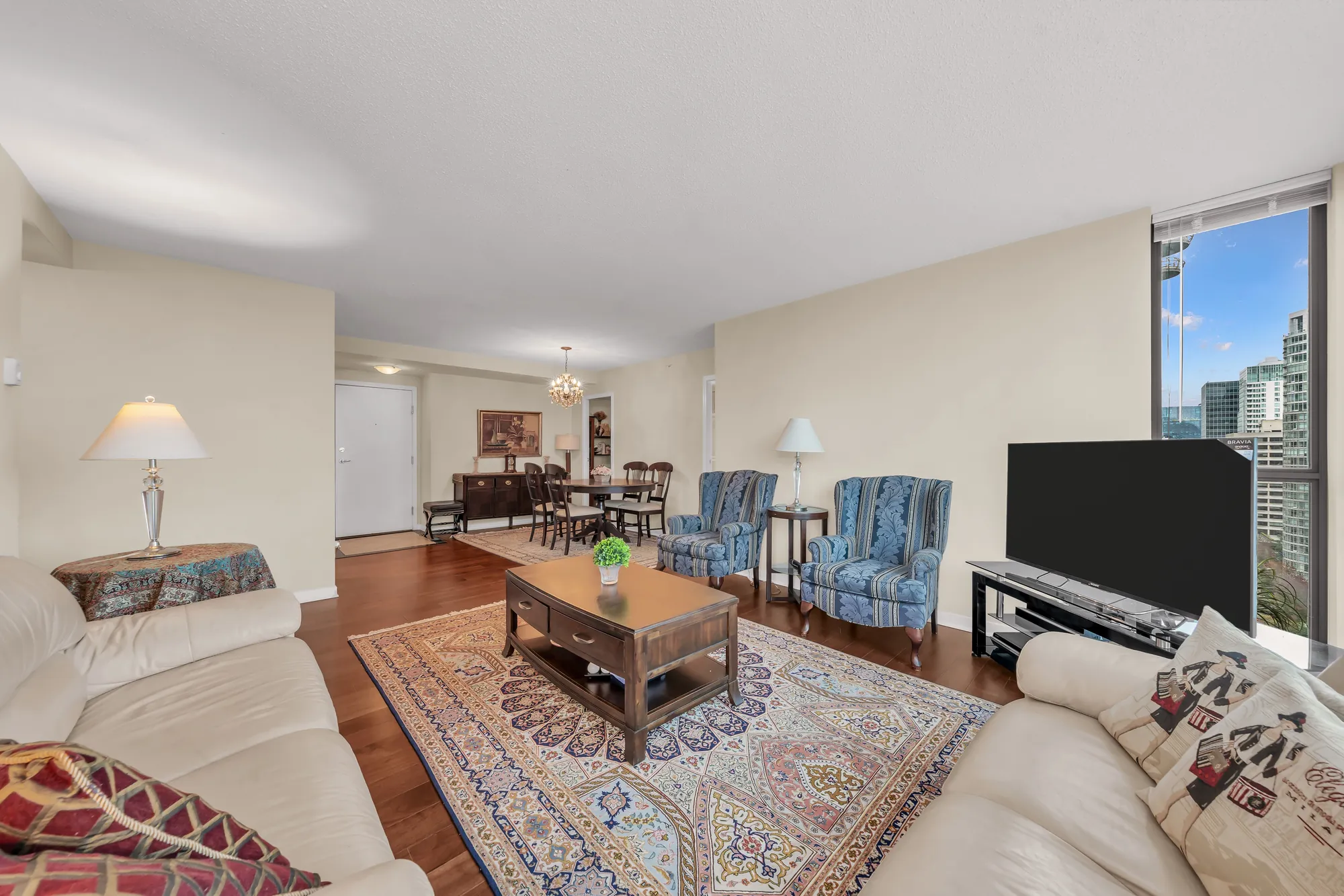 From the windows back across the living room to the dining table, the chandelier and the front door